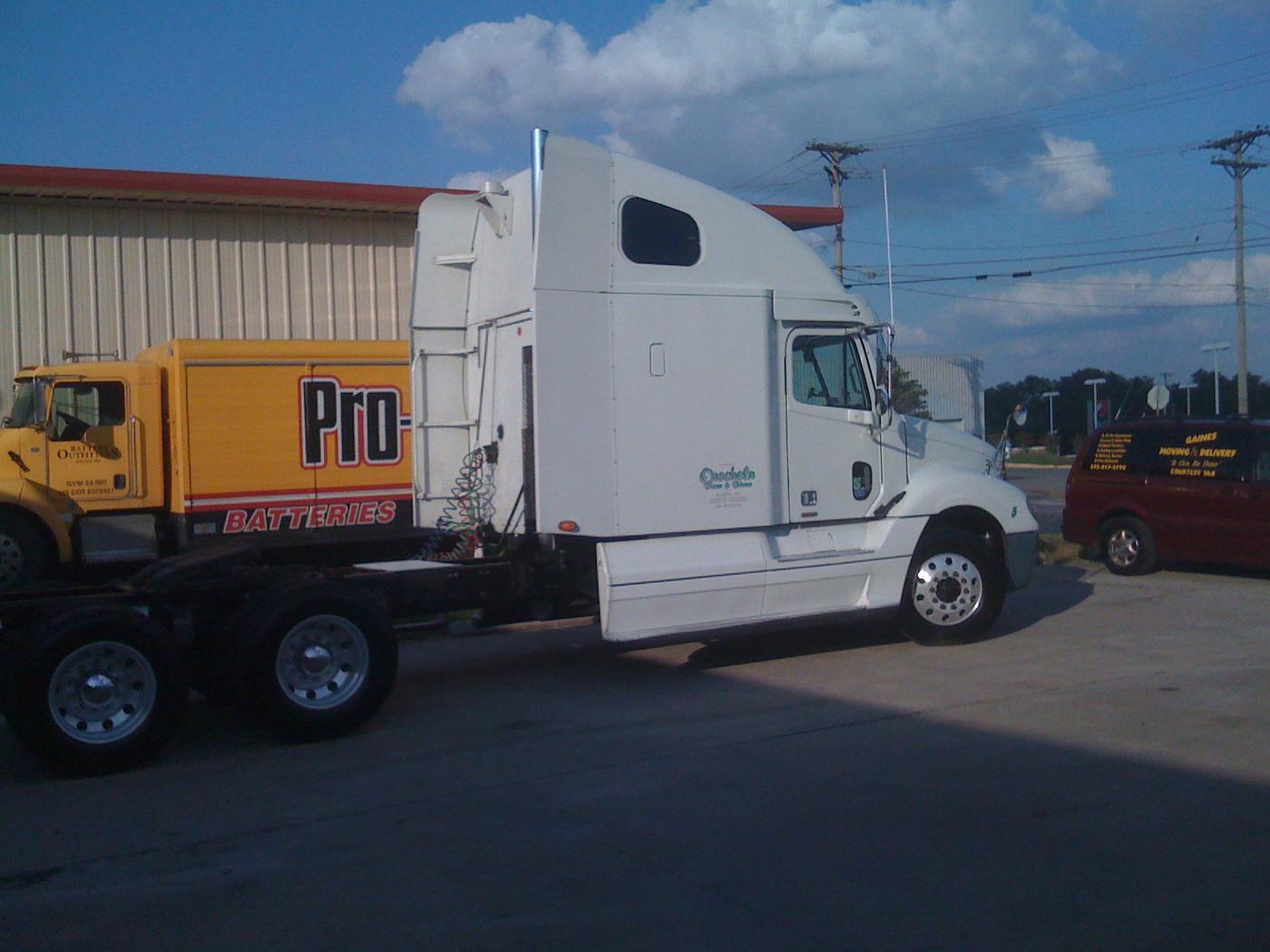 A white semi tractor on the forecourt at Gaines, with the Gaines Moving and Delivery courtesy van parked alongside