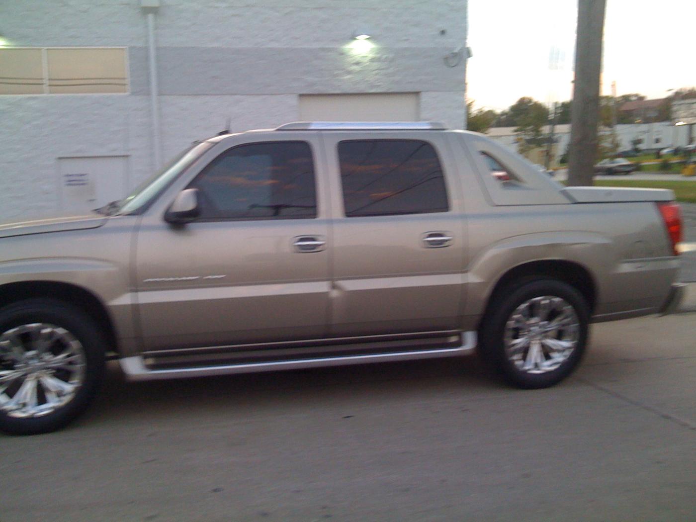 A silver Cadillac Escalade EXT on chrome wheels after a detail